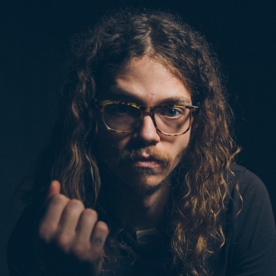 brent wearing classes long curly hair