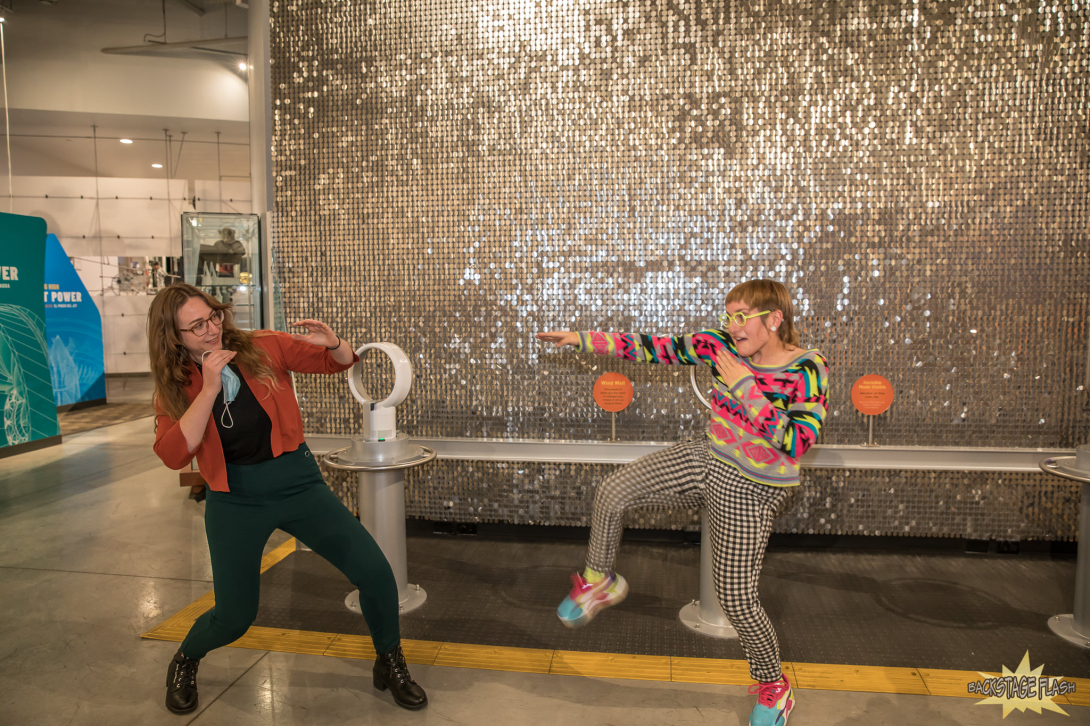 in front of sparkle wall musicians perform 
