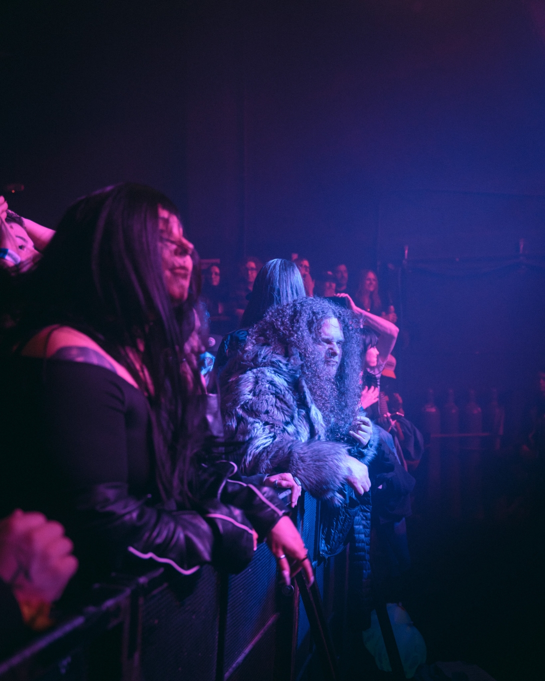 Concert-goers looking up at the stage, captivated.